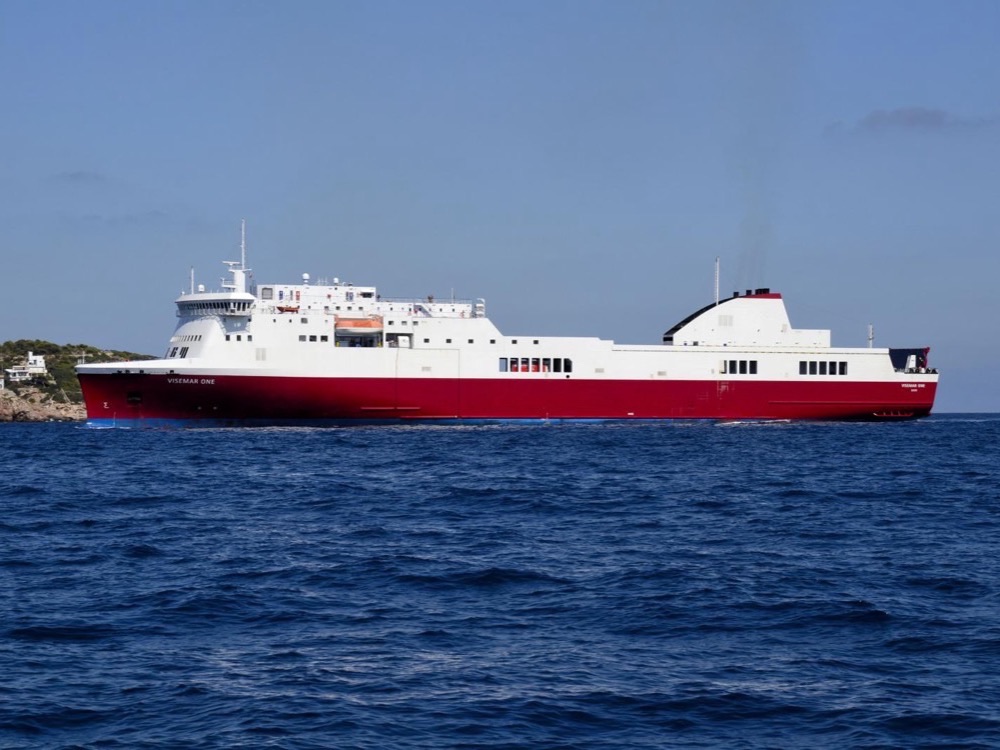 A white and red car ferry at sea off Ibiza