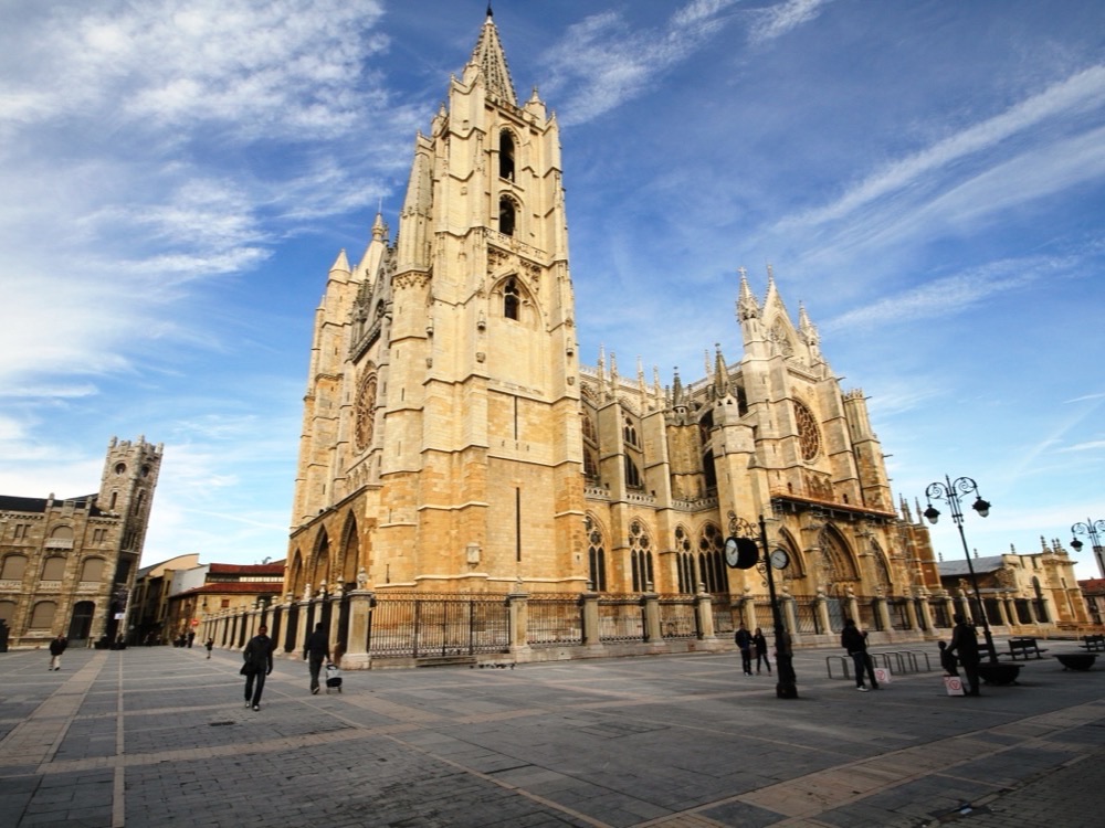 León Cathedral on its square under a blue sky