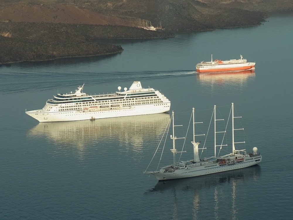Cruise ships and a sailing ship at anchor in the caldera of Santorini