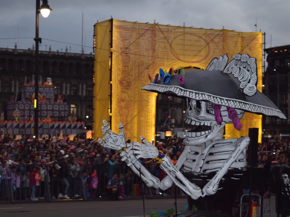 A giant Catrina figure in front of the crowd in the Zócalo, Mexico City