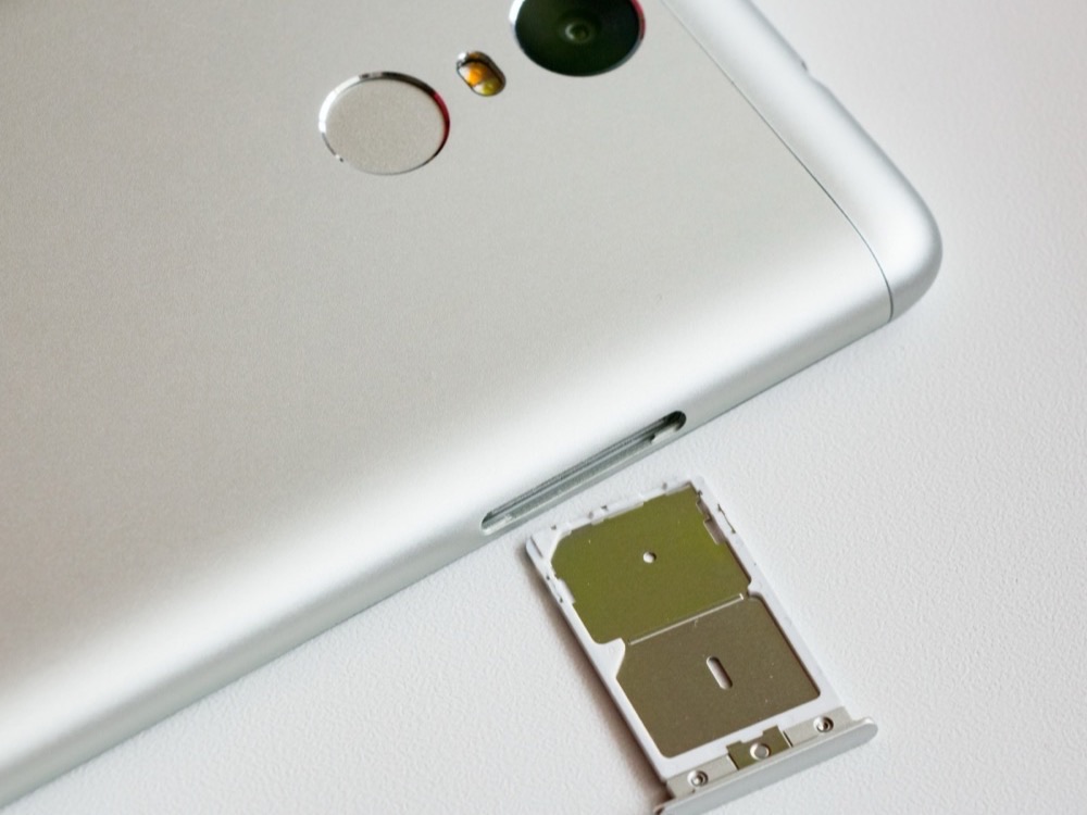 The dual SIM card tray of a Xiaomi Redmi Note 3, pulled out of the phone