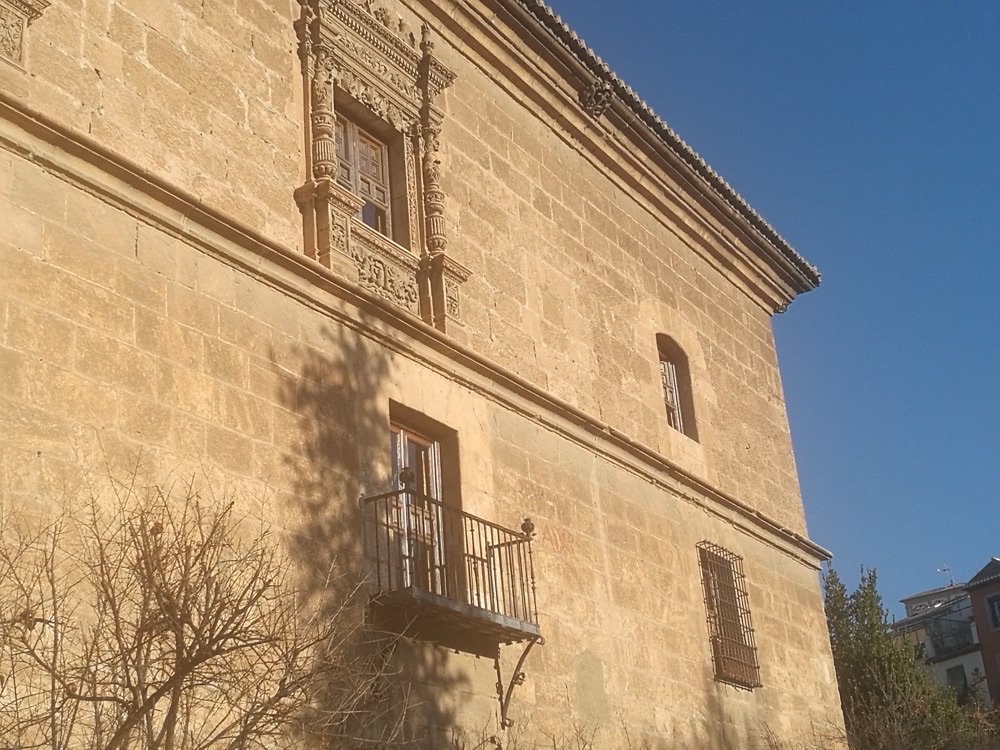 The stone facade of the Hospital Real, seat of the University of Granada