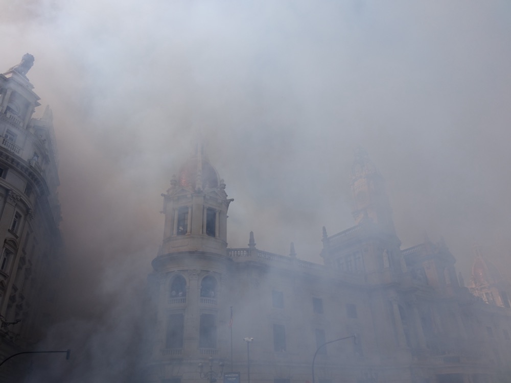Thick smoke over the town hall in the Plaza del Ayuntamiento in Valencia just after a mascletà