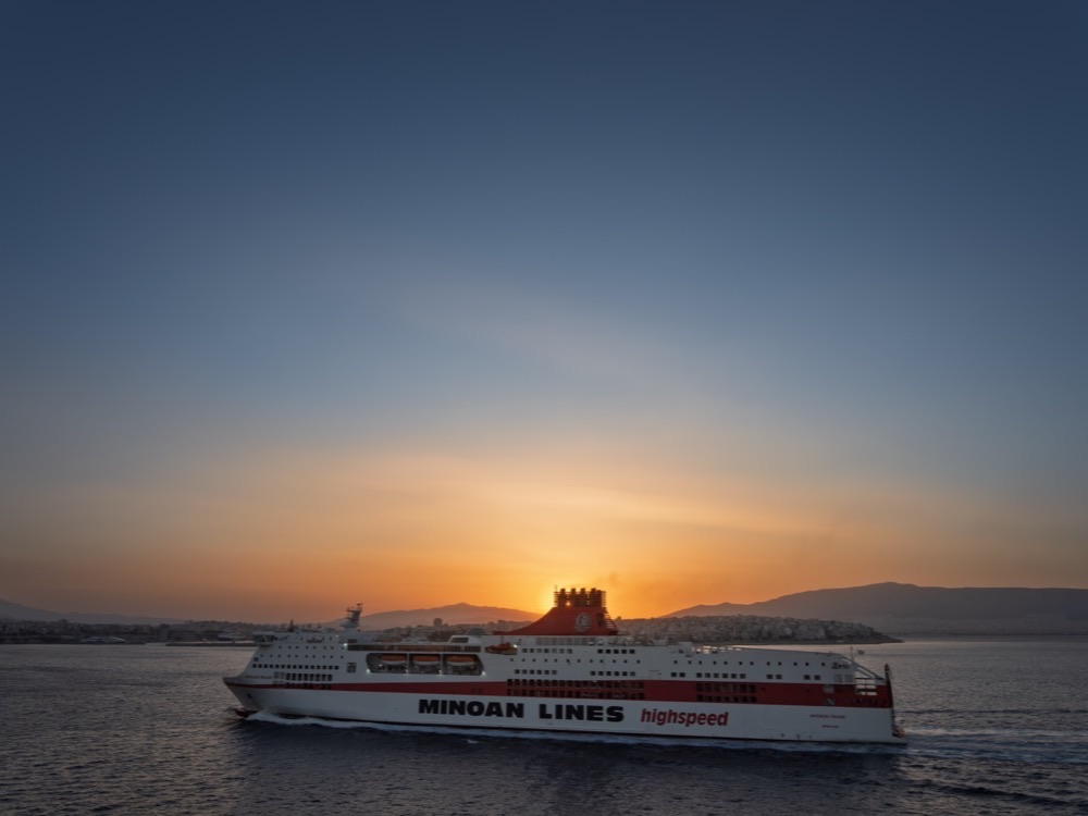 A large ferry leaving the harbour of Piraeus at sunset