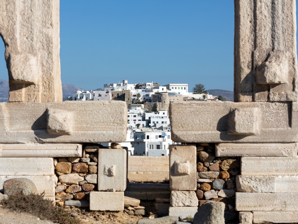 Naxos Chora framed by the marble doorway of the Portara