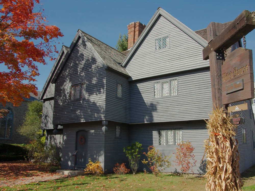 The Witch House in Salem, a dark seventeenth-century timber house, with autumn leaves