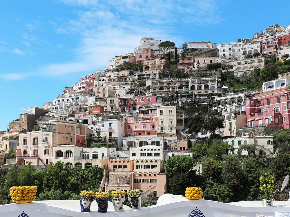 The houses of Positano stacked up the cliff above the beach