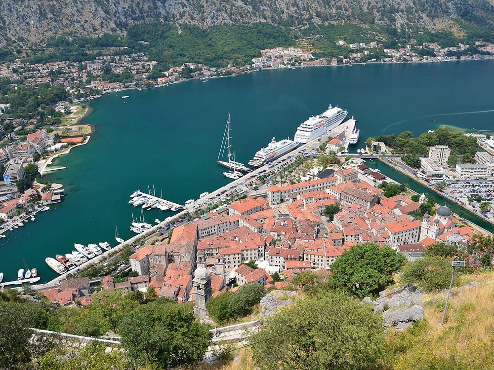 The old town of Kotor, Montenegro, with cruise ships in the bay below