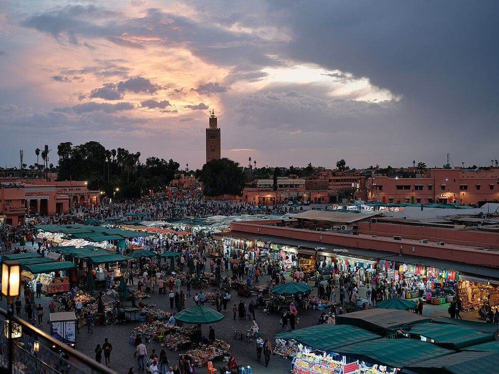 Jemaa el-Fnaa square in Marrakech at night with food stalls and smoke