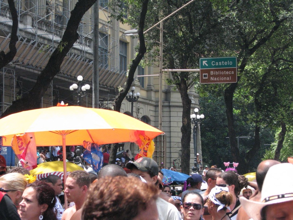 A dense crowd under umbrellas at the Cordão da Bola Preta bloco in central Rio
