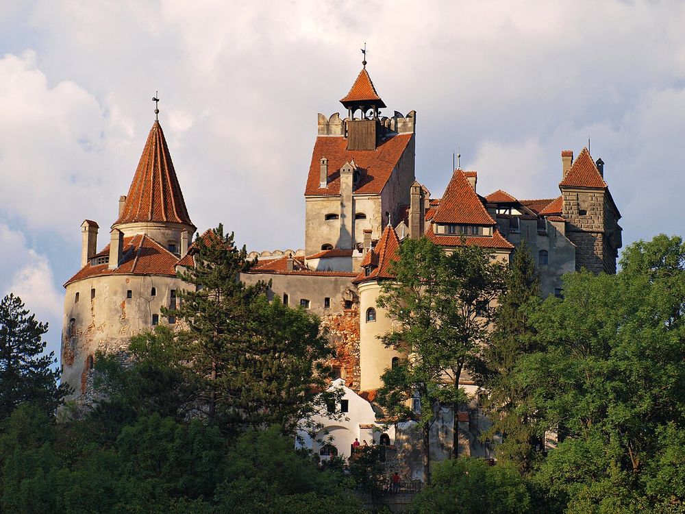 Bran Castle on its rock above the trees in Transylvania