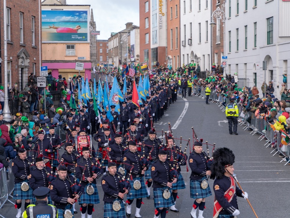 The Dublin Fire Brigade Pipe Band marching in the St Patrick's Day parade, crowds behind the barriers
