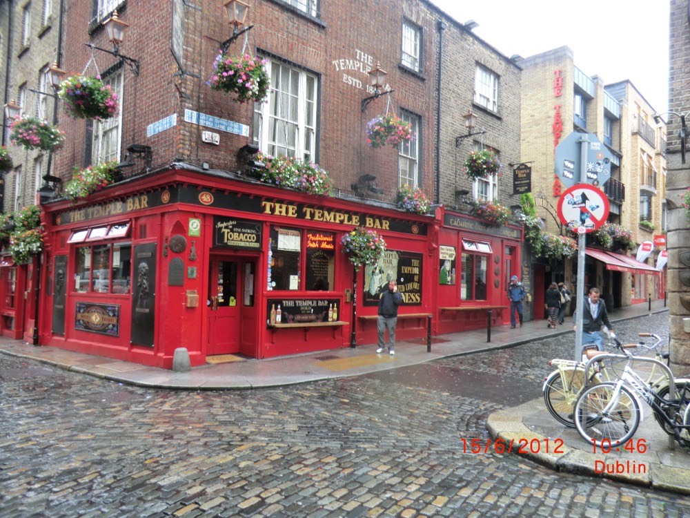 The red front of The Temple Bar pub on a cobbled corner in Dublin