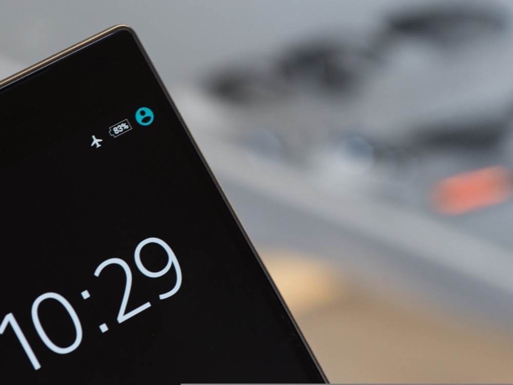 A smartphone lock screen showing the airplane mode icon in the status bar