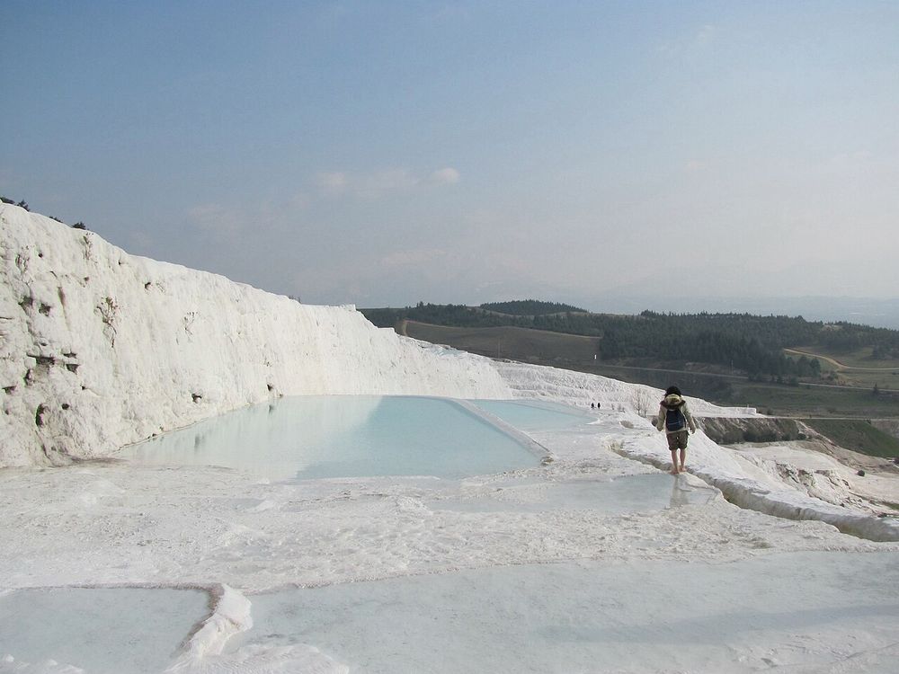 The white travertine terraces of Pamukkale filled with blue water