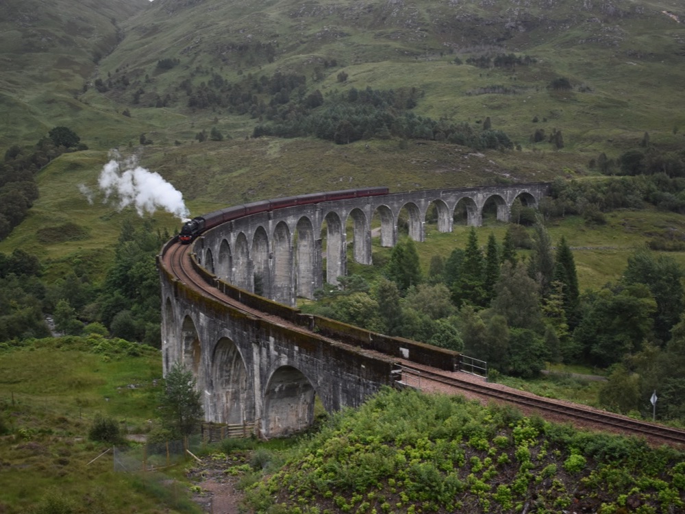 The Jacobite steam train crossing the curved Glenfinnan Viaduct